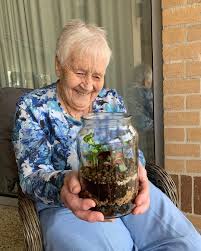 Senior enjoying a terrarium indoors
